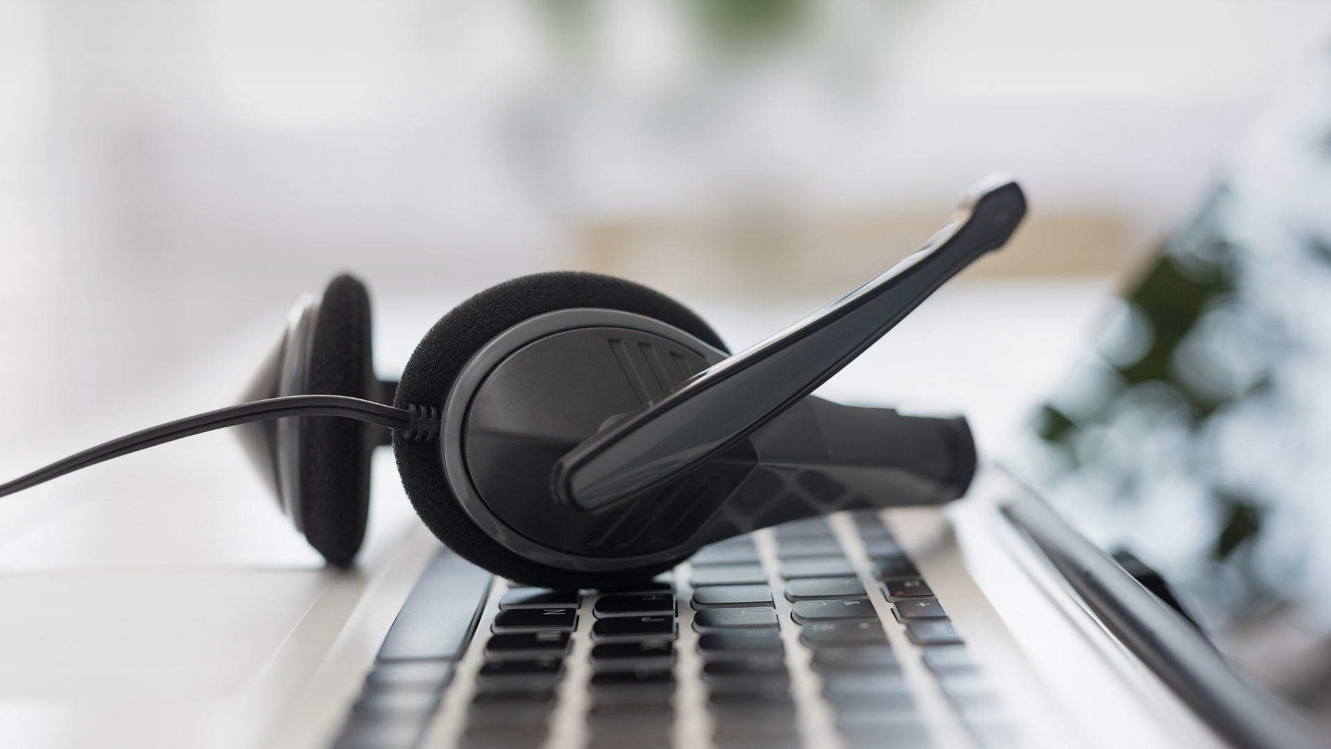 Headphones lying on a computer keyboard.
