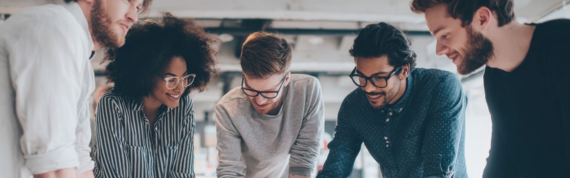 Team sitting around a table, laughing and enjoying themselves.