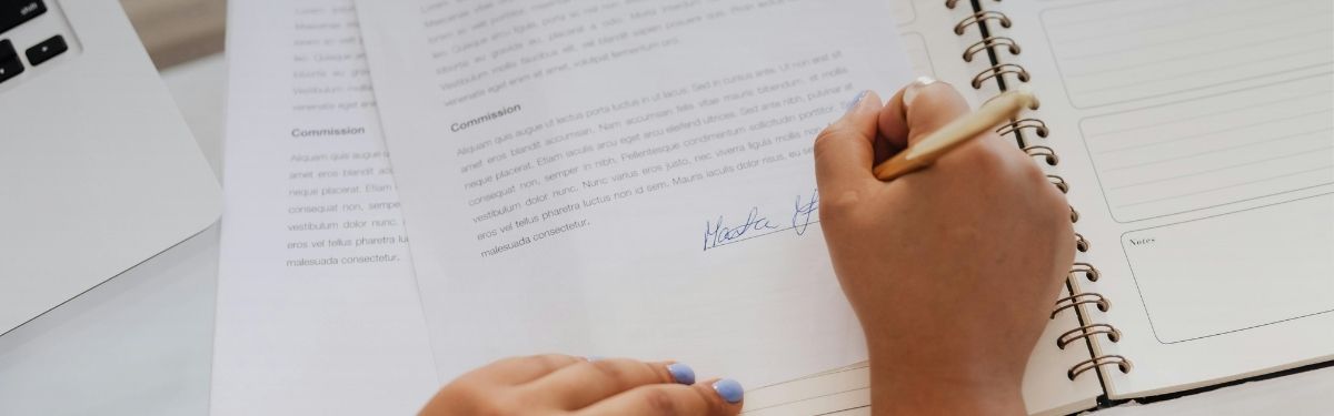 Woman signing a contract.